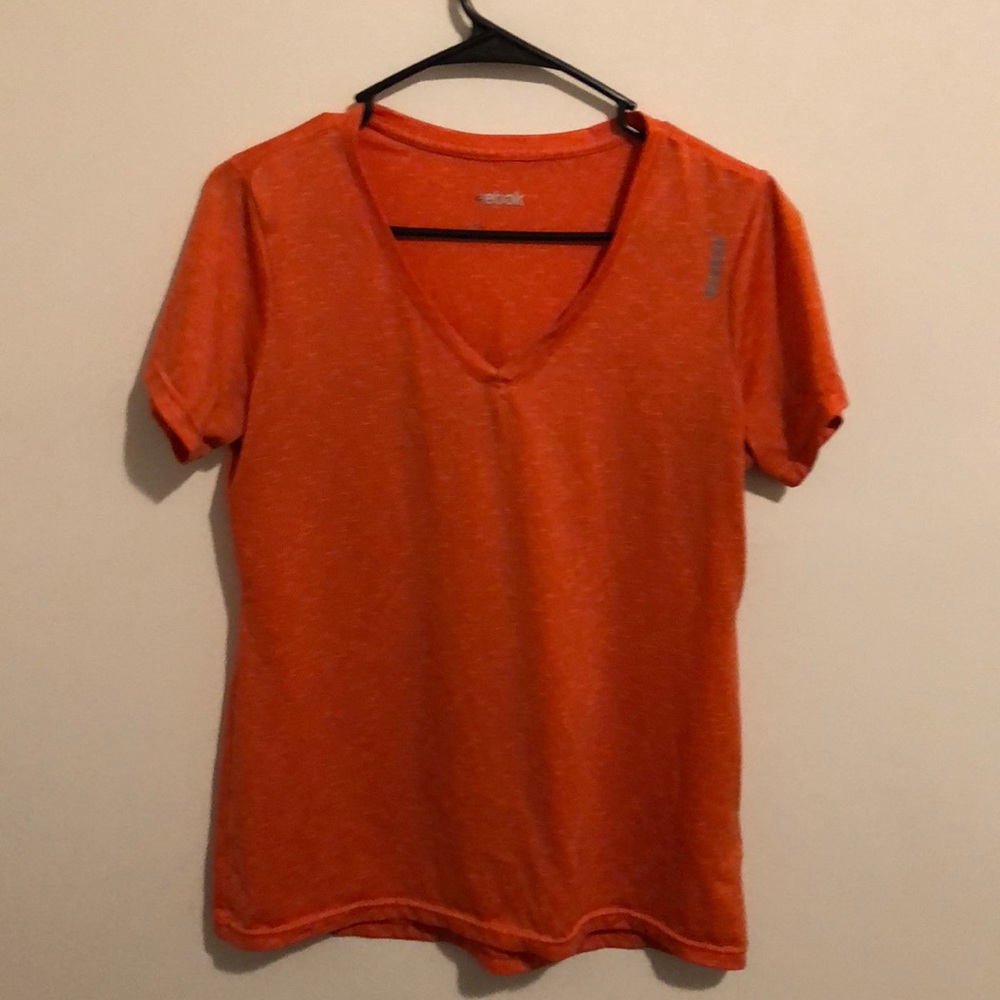 Reebok orange and white tee with v neck.